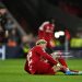 Hugo Ekitike of Liverpool holds his ankle as he appears to be injured during the UEFA Champions League 2025/26 Quarter-Final Second Leg match between Liverpool FC and Paris Saint-Germain FC (Photo by Liverpool FC/Liverpool FC via Getty Images)