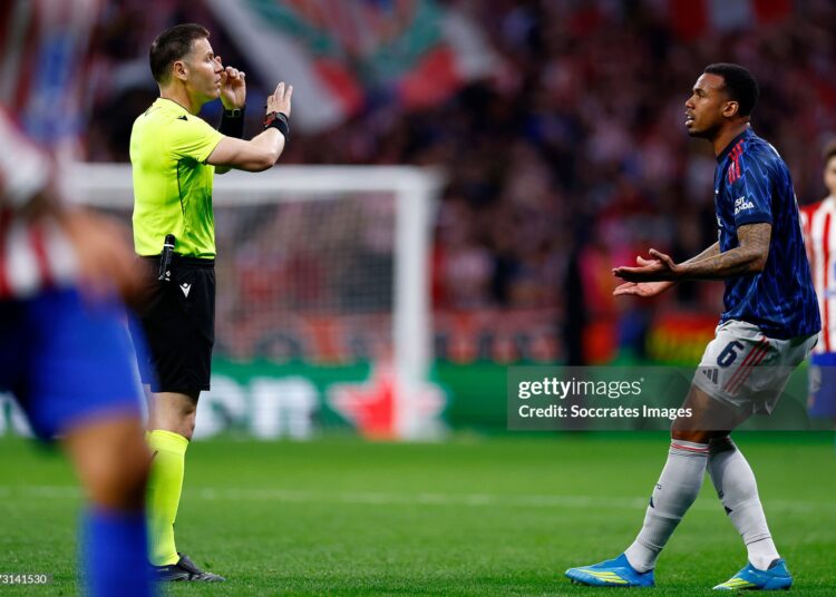 Referee Danny Makkelie argues with Gabriel of Arsenal during the UEFA Champions League  match between Atletico Madrid v Arsenal (Photo by Maria Gracia Jimenez/Soccrates/Getty Images)