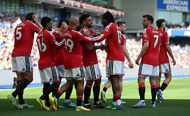 Patrick Dorgu of Manchester United celebrates scoring his team's first goal with teammates during the Premier League match between Brighton & Hove Albion and Manchester United at the Amex Stadium on May 24, 2026 in Brighton, England. (Photo by Mike Hewitt/Getty Images)
