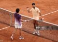 Joao Fonseca of Brazil and Novak Djokovic of Serbia interact at the net following their Men's Singles third round match on Day Six of the 2026 French Open (Photo by James Fearn/Getty Images)