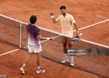 Joao Fonseca of Brazil and Novak Djokovic of Serbia interact at the net following their Men's Singles third round match on Day Six of the 2026 French Open (Photo by James Fearn/Getty Images)