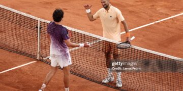 Joao Fonseca of Brazil and Novak Djokovic of Serbia interact at the net following their Men's Singles third round match on Day Six of the 2026 French Open (Photo by James Fearn/Getty Images)