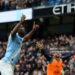 Manchester City's Belgian midfielder #11 Jeremy Doku (L) celebrates after scoring the opening goal during the English Premier League football match between Manchester City and Brentford (Photo by Darren Staples / AFP via Getty Images)