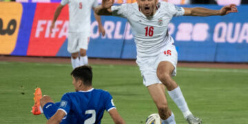 Iran's Mahdi Torabi (16) is reacting while Uzbekistan's Abdukodir Khusanov (2) is lying on the pitch during the FIFA World Cup 26 AFC qualifying round two group E soccer match at the Azadi (Freedom) Stadium in Tehran, Iran, on June 11, 2024. (Photo by Morteza Nikoubazl/NurPhoto via Getty Images)
