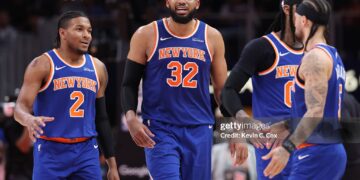 Karl-Anthony Towns #32, Miles McBride #2 and Jose Alvarado #5 of the New York Knicks reacts to the score during the third quarter of a game against the Atlanta Hawks in Game Six of the First Round of the NBA Eastern Conference Playoffs (Photo by Kevin C. Cox/Getty Images)