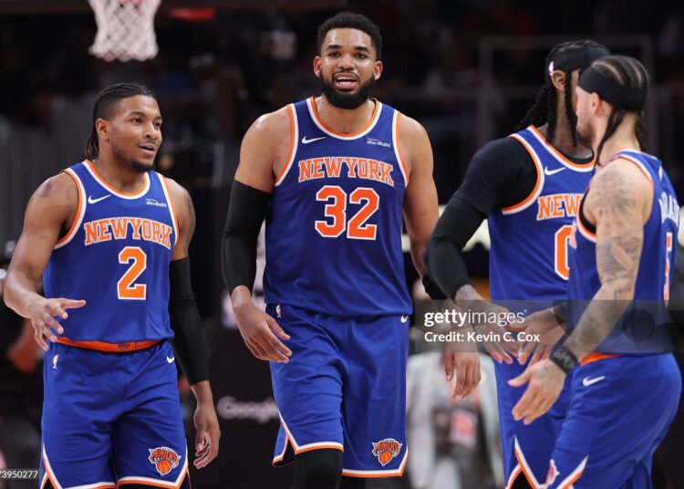Karl-Anthony Towns #32, Miles McBride #2 and Jose Alvarado #5 of the New York Knicks reacts to the score during the third quarter of a game against the Atlanta Hawks in Game Six of the First Round of the NBA Eastern Conference Playoffs (Photo by Kevin C. Cox/Getty Images)