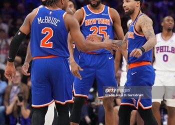 Miles McBride #2, Mikal Bridges #25 and Jose Alvarado #5 of the New York Knicks high five during the game against the Philadelphia 76ers during Round Two Game Four of the 2026 NBA Playoffs  (Photo by Jesse D. Garrabrant/NBAE via Getty Images)
