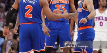 Miles McBride #2, Mikal Bridges #25 and Jose Alvarado #5 of the New York Knicks high five during the game against the Philadelphia 76ers during Round Two Game Four of the 2026 NBA Playoffs  (Photo by Jesse D. Garrabrant/NBAE via Getty Images)