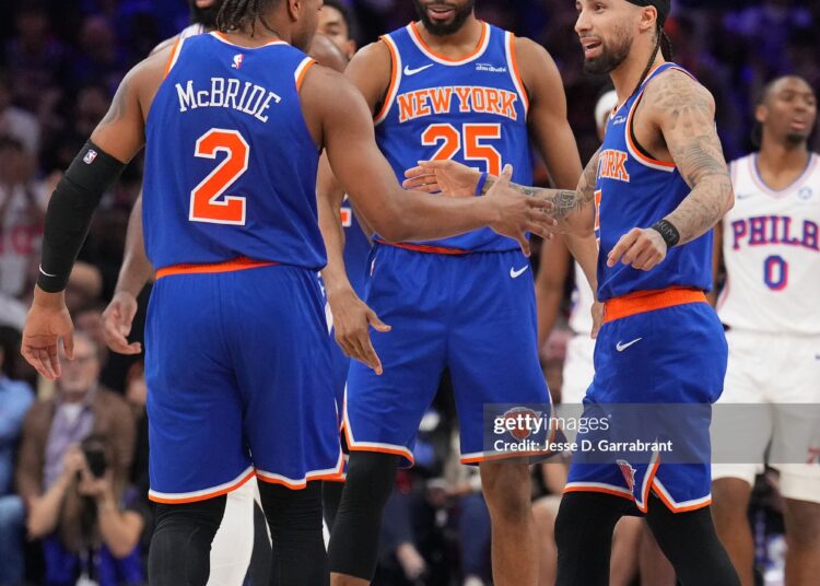 Miles McBride #2, Mikal Bridges #25 and Jose Alvarado #5 of the New York Knicks high five during the game against the Philadelphia 76ers during Round Two Game Four of the 2026 NBA Playoffs  (Photo by Jesse D. Garrabrant/NBAE via Getty Images)