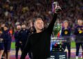 Hansi Flick, Head Coach of FC Barcelona, lifts a miniature of the LaLiga EA Sports trophy as he celebrates after defeating Real Madrid, and winning the LaLiga title, after the LaLiga EA Sports match between FC Barcelona and Real Madrid CF (Photo by Alex Caparros/Getty Images)