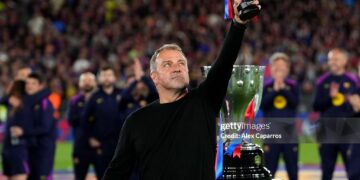 Hansi Flick, Head Coach of FC Barcelona, lifts a miniature of the LaLiga EA Sports trophy as he celebrates after defeating Real Madrid, and winning the LaLiga title, after the LaLiga EA Sports match between FC Barcelona and Real Madrid CF (Photo by Alex Caparros/Getty Images)