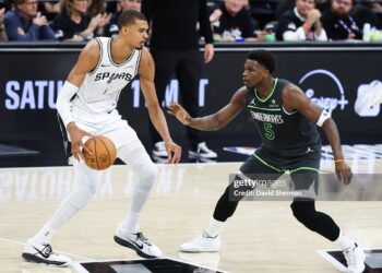 Victor Wembanyama #1 of the San Antonio Spurs handles the ball while defended by Anthony Edwards #5 of the Minnesota Timberwolves during the game during Round Two Game Two (Photos by David Sherman/NBAE via Getty Images)