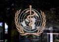 This photograph shows the logo of the World Health Organization (WHO) on the entrance of their headquarters ahead of the 79th World Health Assembly in Geneva, on May 17, 2026. (Photo by Fabrice COFFRINI / AFP via Getty Images)