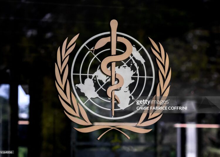 This photograph shows the logo of the World Health Organization (WHO) on the entrance of their headquarters ahead of the 79th World Health Assembly in Geneva, on May 17, 2026. (Photo by Fabrice COFFRINI / AFP via Getty Images)