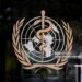 This photograph shows the logo of the World Health Organization (WHO) on the entrance of their headquarters ahead of the 79th World Health Assembly in Geneva, on May 17, 2026. (Photo by Fabrice COFFRINI / AFP via Getty Images)