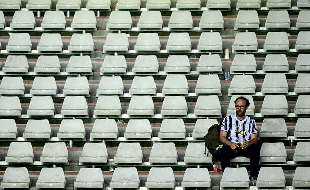 A Juventus' supporter waits for the match to restart after a suspension during the Italian Serie A football match between Torino and Juventus at the Olympic Grande Torino stadium in Turin on May 24, 2026. (Photo by MARCO BERTORELLO / AFP via Getty Images)