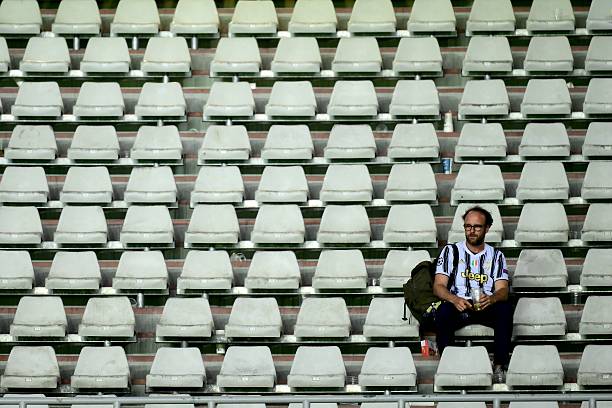 A Juventus' supporter waits for the match to restart after a suspension during the Italian Serie A football match between Torino and Juventus at the Olympic Grande Torino stadium in Turin on May 24, 2026. (Photo by MARCO BERTORELLO / AFP via Getty Images)
