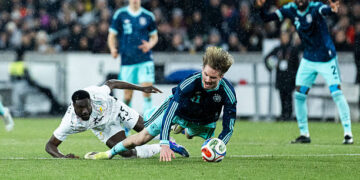 STUTTGART, GERMANY - MARCH 30: Derrick Luckassen of ghana challenges Nick Woltemade of Germany during the international friendly match between Germany and Ghana at MHP Arena on March 30, 2026 in Stuttgart, Germany. (Photo by Mika Volkmann/Getty Images)