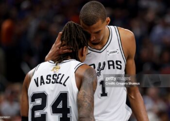 Devin Vassell #24 and Victor Wembanyama #1 of the San Antonio Spurs react during the fourth quarter against the New York Knicks in Game Five of the 2026 NBA Finals (Photo by Gregory Shamus/Getty Images)