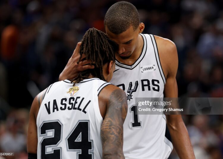 Devin Vassell #24 and Victor Wembanyama #1 of the San Antonio Spurs react during the fourth quarter against the New York Knicks in Game Five of the 2026 NBA Finals (Photo by Gregory Shamus/Getty Images)