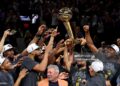 Jalen Brunson #11 of the New York Knicks lifts the Larry O'Brien Championship Trophy after the victory against the San Antonio Spurs in Game Five of the 2026 NBA Finals (Photo by Gregory Shamus/Getty Images)