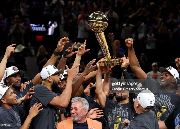 Jalen Brunson #11 of the New York Knicks lifts the Larry O'Brien Championship Trophy after the victory against the San Antonio Spurs in Game Five of the 2026 NBA Finals (Photo by Gregory Shamus/Getty Images)