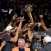 Jalen Brunson #11 of the New York Knicks lifts the Larry O'Brien Championship Trophy after the victory against the San Antonio Spurs in Game Five of the 2026 NBA Finals (Photo by Gregory Shamus/Getty Images)