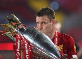 James Milner of Liverpool kisses the trophy to celebrate winning the League Title during the presentation ceremony of  the Premier League match between Liverpool FC and Chelsea FC at Anfield on July 22, 2020 in Liverpool, England. Football Stadiums around Europe remain empty due to the Coronavirus Pandemic as Government social distancing laws prohibit fans inside venues resulting in games being played behind closed doors. (Photo by Laurence Griffiths/Getty Images)