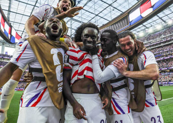 United States of America forward Folarin Balogun (20), center, celebrates with teammates after his second goal during the first half of a World Cup group stage match between United States and Paraguay at the SoFi Stadium on Friday, June 12, 2026 in Inglewood, CA. (Robert Gauthier / Los Angeles Times via Getty Images)