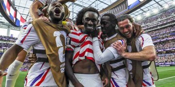 United States of America forward Folarin Balogun (20), center, celebrates with teammates after his second goal during the first half of a World Cup group stage match between United States and Paraguay at the SoFi Stadium on Friday, June 12, 2026 in Inglewood, CA. (Robert Gauthier / Los Angeles Times via Getty Images)