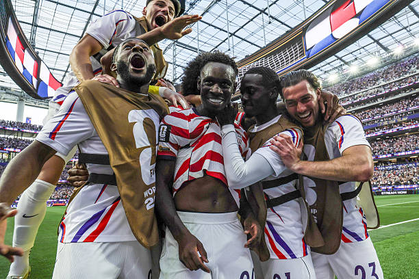 United States of America forward Folarin Balogun (20), center, celebrates with teammates after his second goal during the first half of a World Cup group stage match between United States and Paraguay at the SoFi Stadium on Friday, June 12, 2026 in Inglewood, CA. (Robert Gauthier / Los Angeles Times via Getty Images)