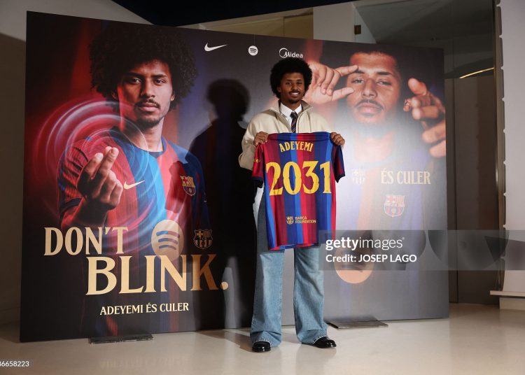 German footballer Karim Adeyemi poses with a jersey bearing his name during his official presentation as FC Barcelona's new player on July 23, 2026 in Barcelona. Barcelona signed forward Karim Adeyemi  (Photo by Josep LAGO / AFP via Getty Images)