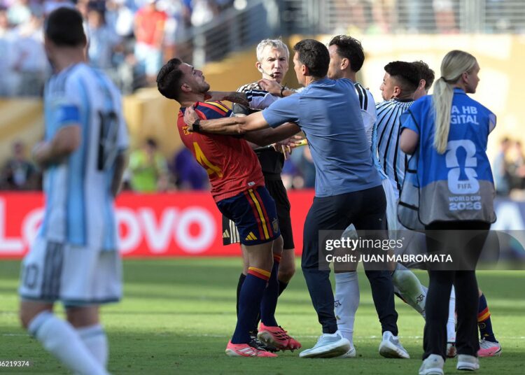 Argentina's head coach Lionel Scaloni (C,R) tries to intervene as Argentina's midfielder #05 Leandro Paredes clashes with Spain's defender #04 Eric Garcia at the end of the 2026 World Cup football tournament final match between Spain and Argentina at the New York/New Jersey Stadium in East Rutherford on July 19, 2026.  (Photo by JUAN MABROMATA / AFP via Getty Images) / "The erroneous mention appearing in the metadata of this photo by JUAN MABROMATA has been modified in AFP systems in the following manner: [Argentina's head coach Lionel Scaloni (C,R) tries to intervene as Argentina's midfielder #05 Leandro Paredes clashes with Spain's defender #04 Eric Garcia] instead of [Argentina's head coach Lionel Scaloni (C,R) clashes with Spain's defender #04 Eric Garcia].