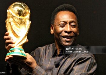 Brazilian football star Pele displays the FIFA World Cup during its presentation in Rio de Janeiro, Brazil on February 6, 2010. (Photo by Gabriel LOPES / AFP via Getty Images)