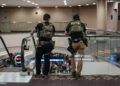Law enforcement agents as travelers wait in line to be screened at a Transportation Security Administration (TSA) checkpoint at Hartsfield-Jackson Atlanta International Airport (ATL) Photographer: Elijah Nouvelage/Bloomberg via Getty Images