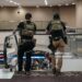 Law enforcement agents as travelers wait in line to be screened at a Transportation Security Administration (TSA) checkpoint at Hartsfield-Jackson Atlanta International Airport (ATL) Photographer: Elijah Nouvelage/Bloomberg via Getty Images