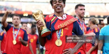 Lamine Yamal #19 of Spain celebrates with the FIFA World Cup Winner’s Trophy after the team’s victory following the FIFA World Cup 2026 Final match between Spain and Argentina (Photo by Alex Pantling - FIFA/FIFA via Getty Images)