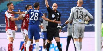 Referee Anthony Taylor shows Cesar Azpilicueta of Chelsea the yellow card during the FA Cup Final match between Arsenal and Chelsea at Wembley Stadium on August 01, 2020 in London, England. Football Stadiums around Europe remain empty due to the Coronavirus Pandemic as Government social distancing laws prohibit fans inside venues resulting in all fixtures being played behind closed doors. (Photo by David Price/Arsenal FC via Getty Images)