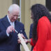 Britain's King Charles III places his message into the Commonwealth baton which is held by Kadeena Cox during the launch of the Commonwealth Sport King's Baton Relay, officially starting the countdown towards the Glasgow 2026 Commonwealth Games, at Buckingham Palace in London on March 10, 2025. (Photo by Jonathan Brady / POOL / AFP) (Photo by JONATHAN BRADY/POOL/AFP via Getty Images)