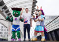 Swimmer Duncan Scott poses with mascots Clyde (left) and Finnie (right) on Bell's Bridge after his journey up the River Clyde in Glasgow for the official launch of the Scotland leg of the King's Baton Relay. The baton will travel from the Team Scotland camp in Glasgow to more than 50 events across the country, celebrating Scottish sport, culture, the Commonwealth and the Games. Picture date: Wednesday July 1, 2026. (Photo by Jane Barlow/PA Images via Getty Images)