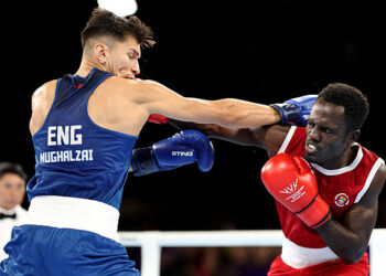 Patris Mughalzai of Team England and Abdul Wahib Omar of Team Ghana exchange punches during the Men's 65kg Round of 32 match on day one of the Glasgow 2026 Commonwealth Games at SEC Centre on July 24, 2026 in Glasgow, Scotland. (Photo by Lintao Zhang/Getty Images)