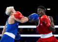 Amadu Mohammed of Team Ghana punches Jye Dixon of Team Australia during the Men's 55kg Semi-Final match on day eight of the Glasgow 2026 Commonwealth Games at SEC Centre on July 31, 2026 in Glasgow, Scotland. (Photo by Mattia Ozbot/Getty Images)