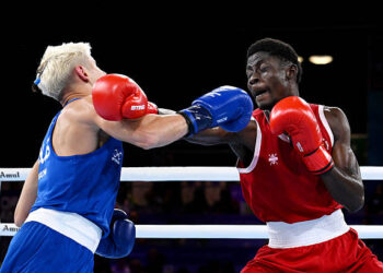 Amadu Mohammed of Team Ghana punches Jye Dixon of Team Australia during the Men's 55kg Semi-Final match on day eight of the Glasgow 2026 Commonwealth Games at SEC Centre on July 31, 2026 in Glasgow, Scotland. (Photo by Mattia Ozbot/Getty Images)