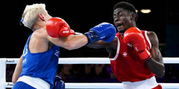 Amadu Mohammed of Team Ghana punches Jye Dixon of Team Australia during the Men's 55kg Semi-Final match on day eight of the Glasgow 2026 Commonwealth Games at SEC Centre on July 31, 2026 in Glasgow, Scotland. (Photo by Mattia Ozbot/Getty Images)