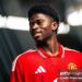 Carlos Baleba of Manchester United poses after signing for the club (Photo by Manchester United/Manchester United via Getty Images)
