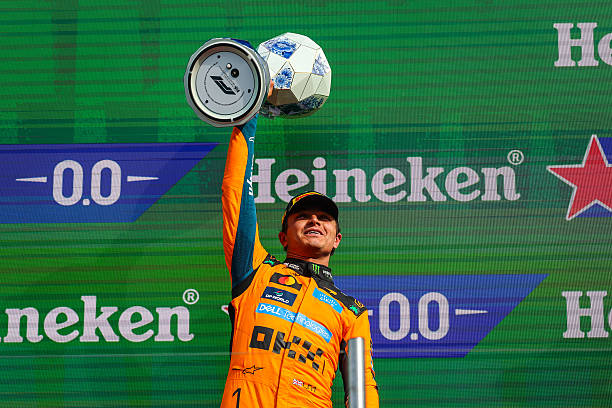 Lando Norris of Great Britain and McLaren Mastercard F1 Team raises his trophy in celebration on the podium during the F1 Grand Prix of Netherlands at Circuit Zandvoort on August 23, 2026 in Zandvoort, Netherlands. (Photo by Kym Illman/Getty Images)