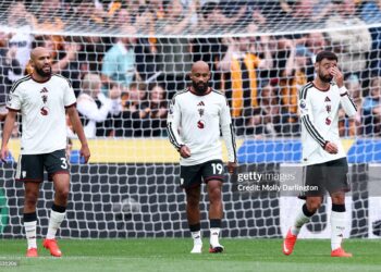 (L-R) Noussair Mazraoui, Bryan Mbeumo and Bruno Fernandes of Manchester United react after their side concedes a goal during the Premier League 2026/27 match between Hull City and Manchester United (Photo by Molly Darlington/Getty Images)