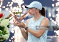Iga Swiatek of Poland poses with the trophy after defeating Elena Rybaina of Kazakhstan (Photo by Matthew Stockman/Getty Images)