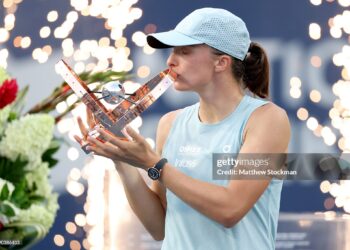 Iga Swiatek of Poland poses with the trophy after defeating Elena Rybaina of Kazakhstan (Photo by Matthew Stockman/Getty Images)