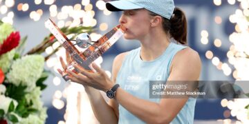 Iga Swiatek of Poland poses with the trophy after defeating Elena Rybaina of Kazakhstan (Photo by Matthew Stockman/Getty Images)